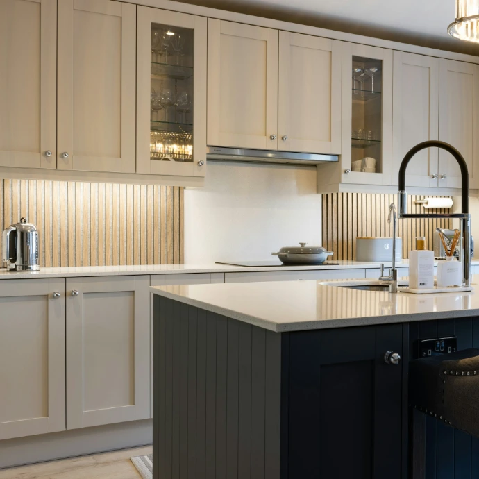 a kitchen with white cabinets and a black island